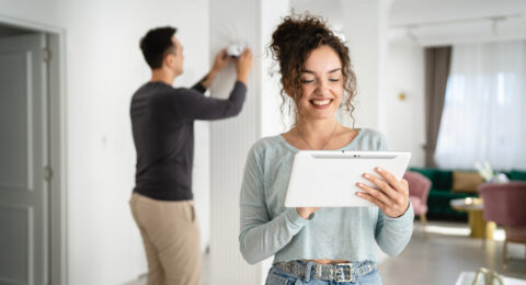 man and woman couple wife husband set up surveillance security camera